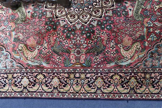 A Persian silk red ground floral medallion rug, 175cm x 122cm